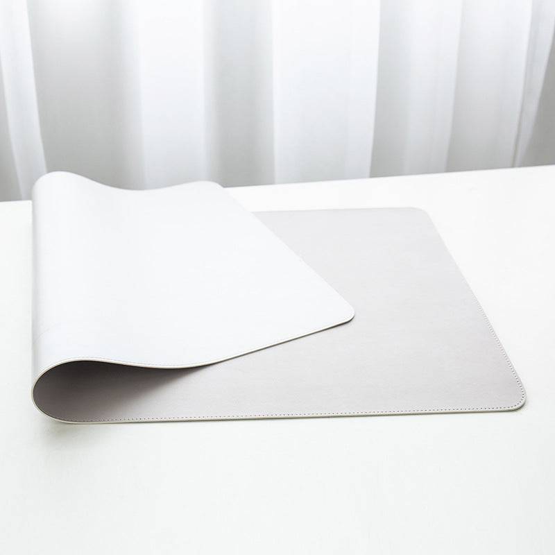 two white sheets of paper on a white table