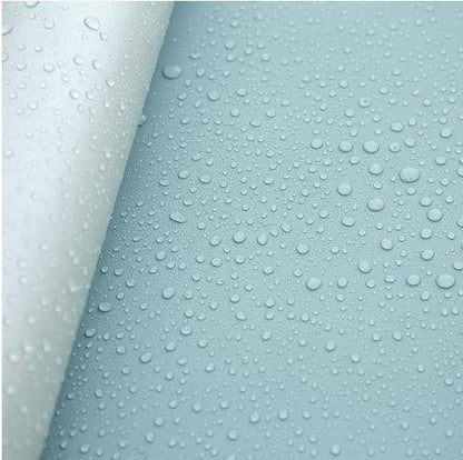 a close up of water droplets on a blue surface