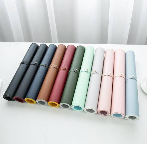 a white table topped with lots of different colored rolls of paper